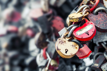 Old rusty padlock on a blurry background. Red and yellow. Old, memory, romance, wedding.の写真素材