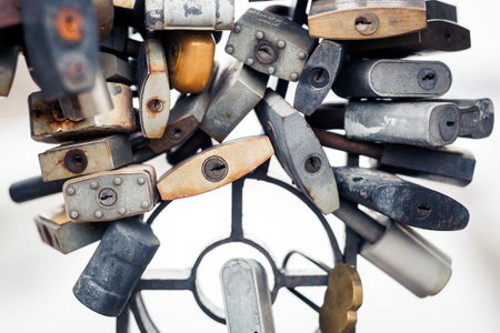 A lot of metal locks silver and gold on the light on the city bridgeの写真素材