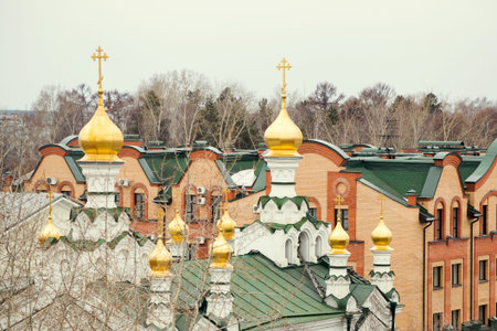 Church with domes. Green roof. City religious landscape