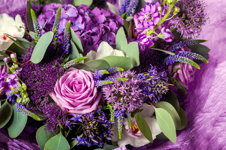 Purple bouquet with a variety of colors. Roses, hydrangeas, lilacs, greens, leaves, orchids. Background of flowersの写真素材