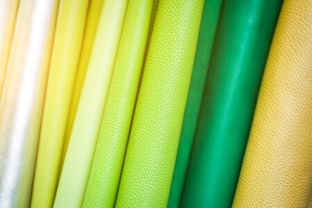 A close-up of colorful leather: green, light green, yellow, beige. Pattern made of genuine leatherの写真素材