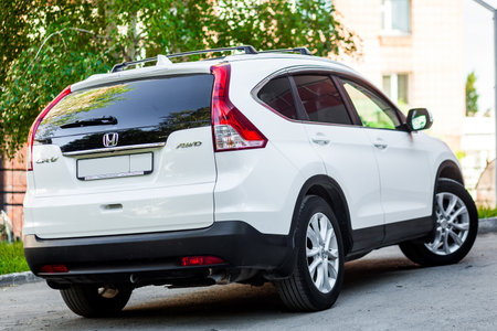 Novosibirsk, Russia -  June 18, 2017: white Honda CRV , side back. Photography of a urban crossover in the street on a summer dayのeditorial素材