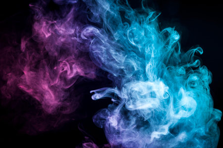 Colorful smoke of blue, pink, purple on a black isolated background. Background from the smoke of vapeの写真素材
