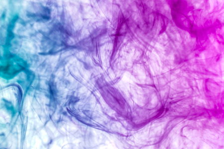 Thick colorful smoke of pink and blue on a white isolated background. Background from the smoke of vapeの写真素材