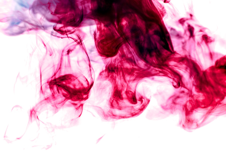 Thick colorful smoke of red on a white isolated background. Background from the smoke of vapeの写真素材