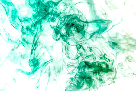 Thick colorful smoke of green on a white isolated background. Background from the smoke of vapeの写真素材