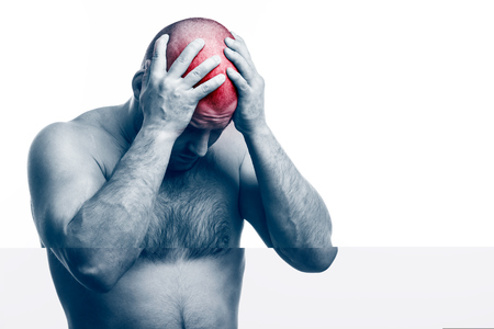 Pain in the  head.  Young bald man sports physique suffers and holds a sick head on a white isolated background. Ð eadacheの写真素材