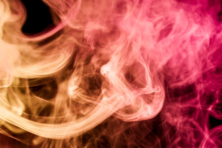 Red and   pink  smoke on black backgroundの写真素材