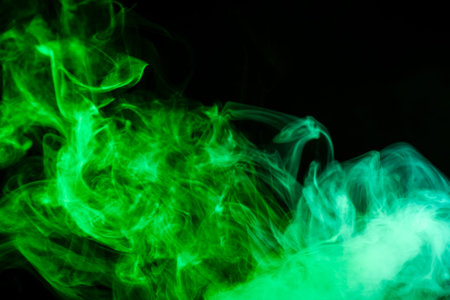 green cloud of smoke of  black isolated background. Background from the smoke of vapeの写真素材