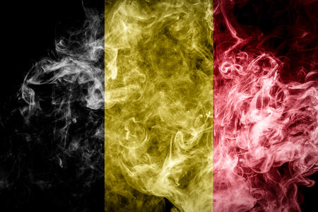 National flag of Belgium from thick colored smoke on a black isolated backgroundの写真素材