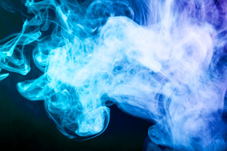 Cloud of blue smoke on a black isolated background. Background from the smoke of vape