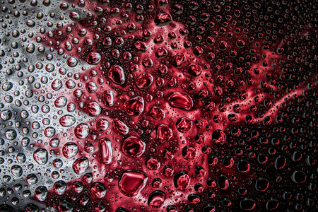 Close-up of a drop of water against a background of the national flag of  Bahrain on an isolated backgroundの写真素材