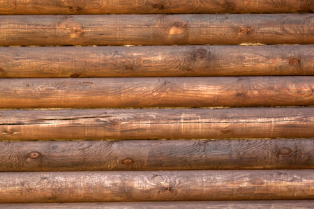 Close-up texture of a wooden brown round logの写真素材