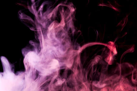 Pink, purple and red smoke on black backgroundの写真素材