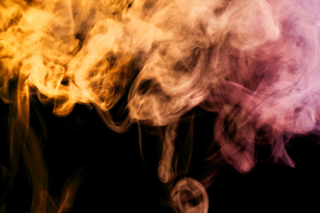 Orange and pink smoke on black background