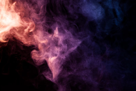 Thick blue,pink and purple smoke on a black isolated background. Background from the smoke of vape
