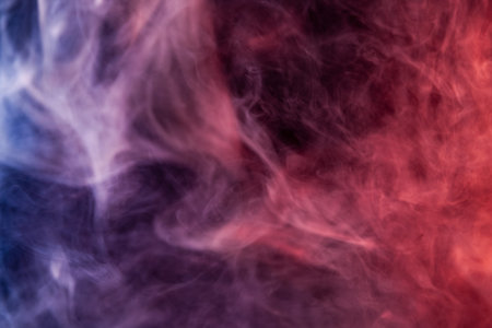 Thick red,blue and white smoke on a black isolated background. Background from the smoke of vape
