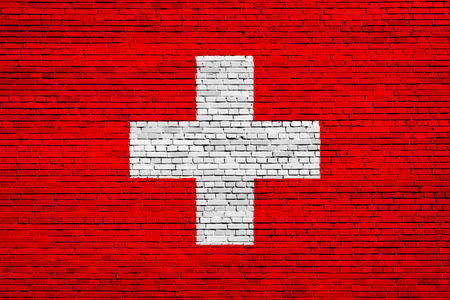 National flag of Switzerland on a brick backgroundの写真素材
