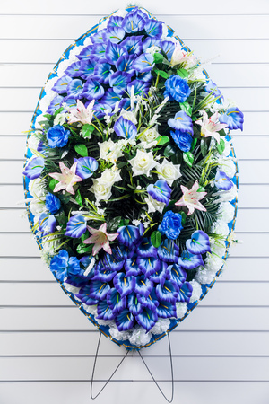Luxury funeral wreath with blue and white flowers on a white striped isolated backgroundの写真素材