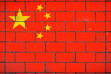National flag of  China against a background of a stone background covered with mossの写真素材
