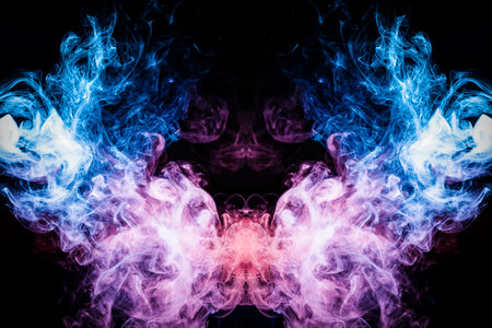 Cloud of blue and pink smoke  in the form of a skull, monster, dragon  on a black isolated background. Background from the smoke of vape. Mocap for cool t-shirtsの写真素材