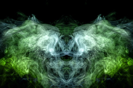 Fluffy Puffs  blue and green smoke and Fog in the form of a skull, monster, dragon  on Black Background. Fantasy print for clothes: t-shirts, sweatshirts.の写真素材