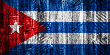 National flag of Cuba on a textured wooden background, fence or wallの写真素材