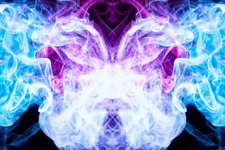 Dense multicolored smoke of   blue and pink colors in the form of a skull, monster, dragon on a black isolated background. Background of smoke vape. Mocap for cool t-shirtsの写真素材