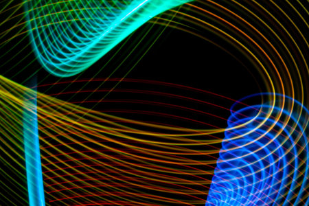 Abstract light blue, pink and purple trails in random motion background image. Striped Neon Lights...
