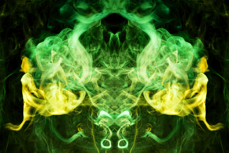 Thick colorful green  and yellow smoke  in the form of a butterfly on a black isolated background. Background from the smoke of vape. Mocap for cool t-shirtsの写真素材