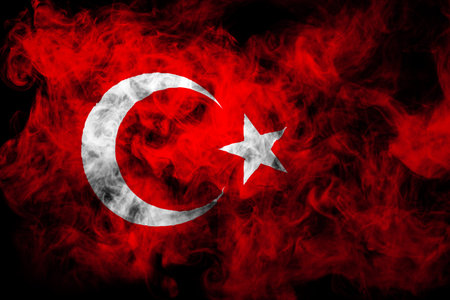 National flag of Turkey from thick colored smoke on a black isolated backgroundの写真素材