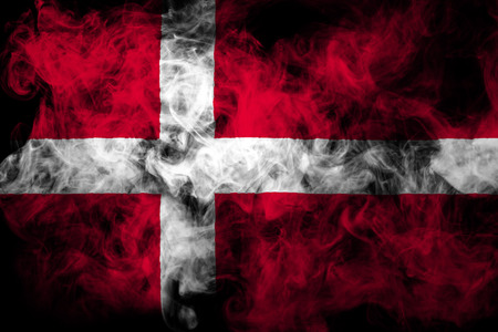 National flag of Denmark from thick colored smoke on a black isolated backgroundの写真素材