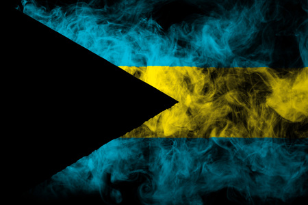 National flag of Bahamas from thick colored smoke on a black isolated backgroundの写真素材