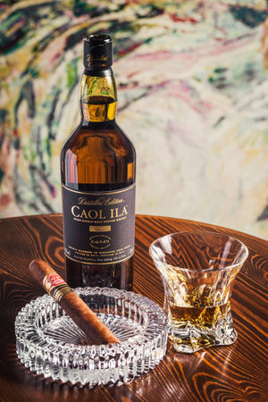 Novosibirsk, Russia - April 07, 2017:  Caol ila Single Malt Whisky,cigar, ashtray and a glass of whiskey   at the bar wooden counterのeditorial素材