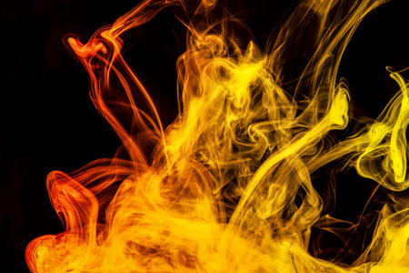 Frozen abstract movement of  explosion yellow and orange smoke multiple colors on black background....