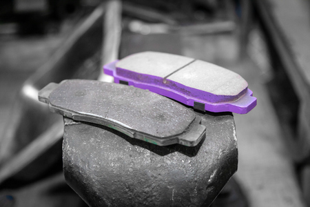 A set of old and new automobile brake pads on a garage.の写真素材