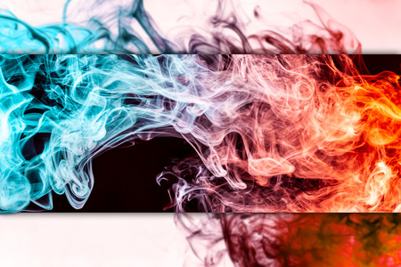 Frozen abstract movement of  explosion red and blue  smoke multiple colors on black background. Background from the smoke of vapeの写真素材