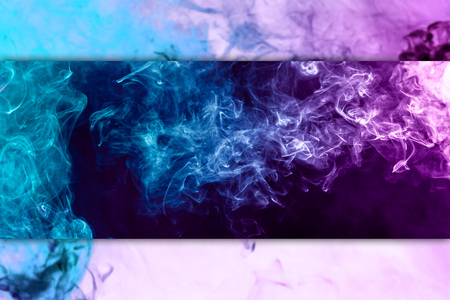 Fog colored with bright pink and blue gel on dark black and white backgroundの写真素材