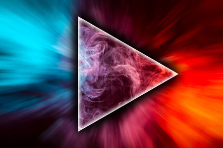 Close up swirling red and blue smoke in the shape of a triangle on black isolated backgroundの写真素材