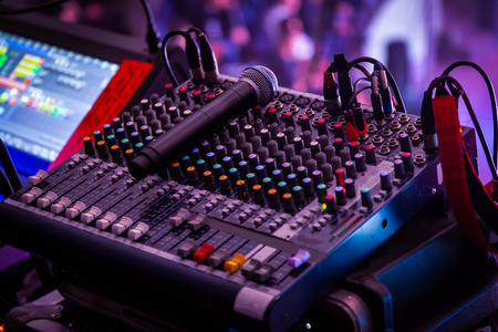 Night club, the concept of nightlife and theatrical life. Professional mixing console at a concert. Remote control for sound engineer. Work place of sound producer at the eventの写真素材