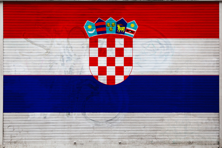 Close-up of old metal wall with national flag of Croatia. Concept of Croatia export-import, storage of goods and national delivery of goods. Flag in grunge styleの写真素材