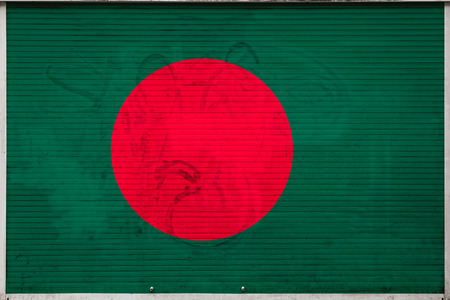 Close-up of old metal wall with national flag of Bangladesh. Concept of Bangladesh export-import, storage of goods and national delivery of goods. Flag in grunge styleの写真素材