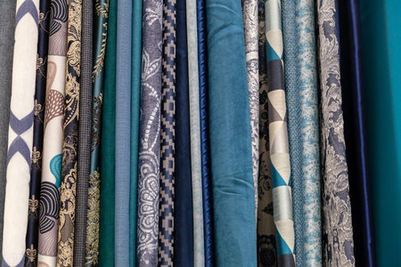 Close-up rows of pieces of fabric made of cotton, polyester, tapestry and other materials of...