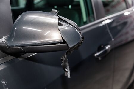 Side car brocken  mirror close-up. Details of gray car の写真素材