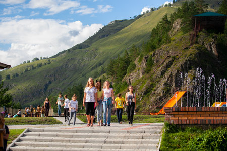 Altai, Russia â August 08, 2018:  a company of teenagers walks and goes to the pool in bathing suits at the summer international camp in the Chemalsky District, Altai Territoryのeditorial素材