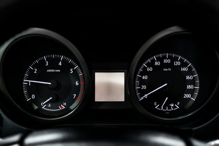 Car dashboard wuth white backlight: Odometer, speedometer, tachometer, fuel level, water temperature and moreの写真素材