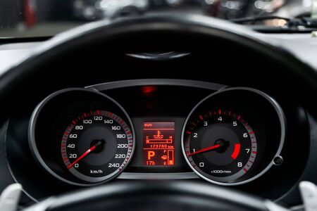 Car dashboard wuth red backlight: Odometer, speedometer, tachometer, fuel level, water temperature and moreの写真素材