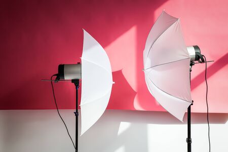 Photography studio flash strobe for light and picture taking on pink color. Tools for professional photographers working in studio.の写真素材