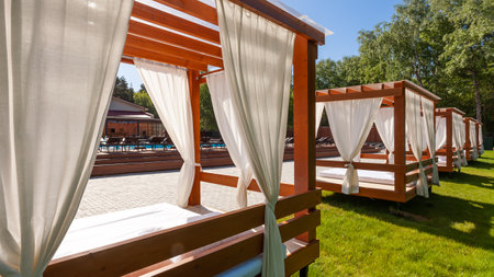 Recreational and relaxing beach scene.   Beach Tent on Terrace near water pool under Sky Sunset in Summerのeditorial素材