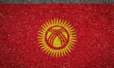 National flag of Kyrgyzstan on a stone background.The concept of national pride and symbol of the country.の写真素材
